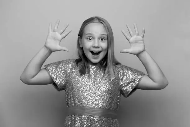 Photo of Happy surprised shocked excited child girl, black and white photo