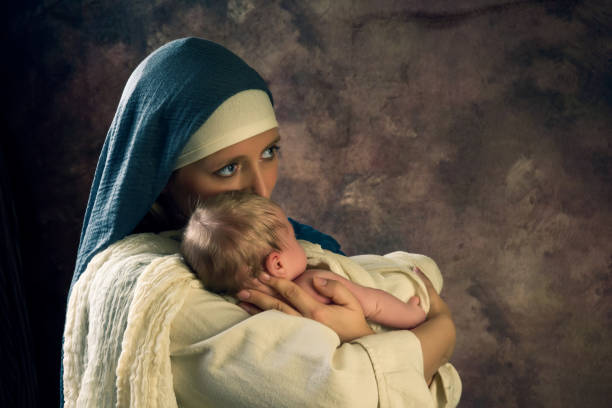Live reenactment Christmas nativity scene of the real mother of an 8 days old baby boy playing Virgin Mary and baby Jesus