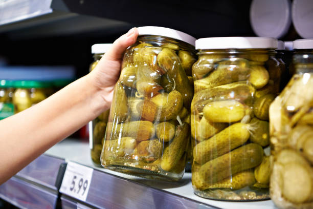 istock Canned cucumbers in hand 1759720080