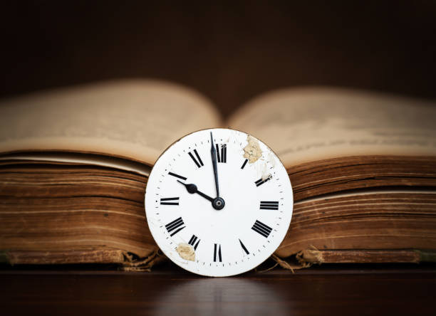 istock Old book and antique clock face, storytelling background 1759721818