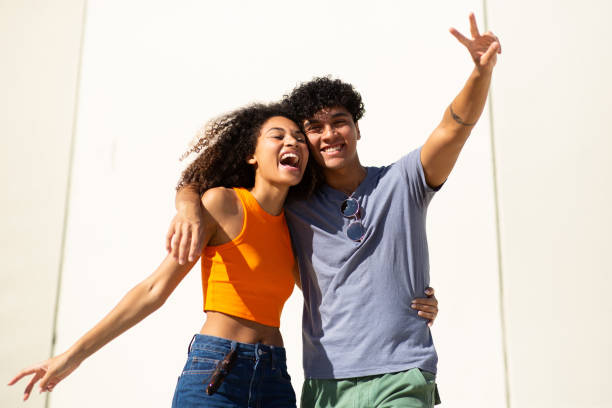 istock cheerful young couple by white wall 1759736084