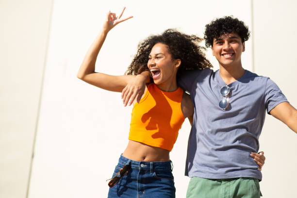 istock happy young couple smiling by white background together 1759736200