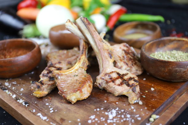 Grilled lamb chops on wooden background stock photo