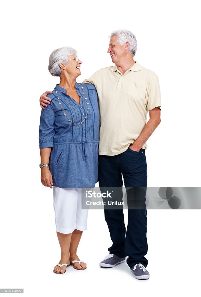Smiling old couple looking at eachother against white  Adult Stock Photo