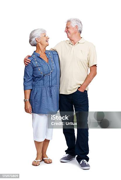 Smiling Old Couple Looking At Eachother Against White Stock Photo - Download Image Now