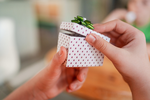 Gift box with a ribbon on red background