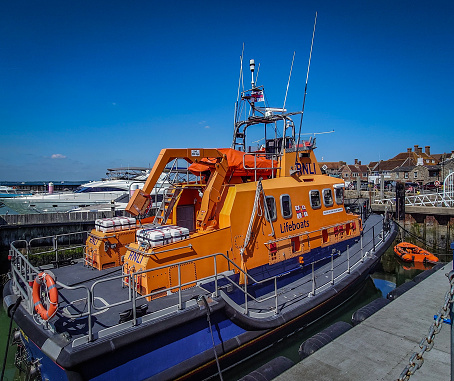 The RNLI 17-25 Severn Lifeboat and the tender boat at anchor in Yarmouth Harbour in May