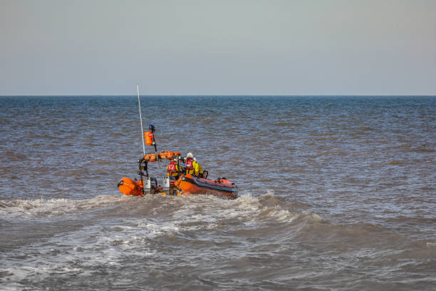 7 JUN 2025 - Cowes, UK - An RNLI coastguard crew in a rescue rib, ready for action at the Isle of Wight, Round the Island Race