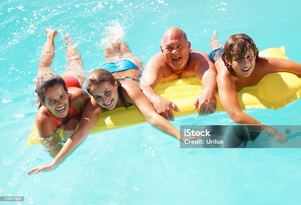 Famiglia felice che si diverte in acqua - Foto stock royalty-free di Adulto