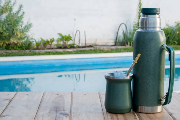 istock Thermos and mate, next to the pool on a table 1759783640