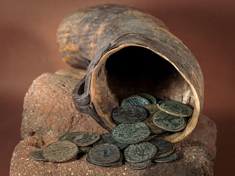 Ancient Roman coins coming out of a cornucopia.