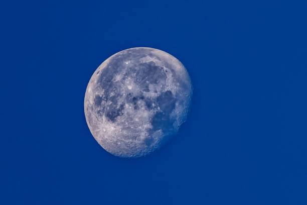 istock Image of a full moon glowing in a tranquil blue night sky 1759783652