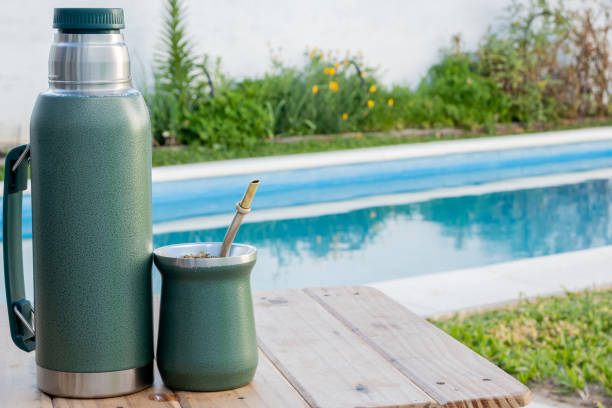 istock Thermos and mate, next to the pool on a table 1759784241