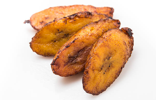 Fried Maduro Plantain Fried Maduro Sweet Plantain on white background Fried Plantain stock pictures, royalty-free photos & images