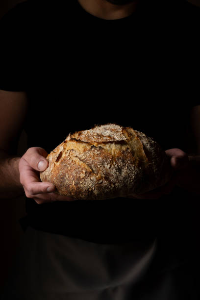 istock Attractive young Caucasian chef posing with white sourdough bread. 1759794062