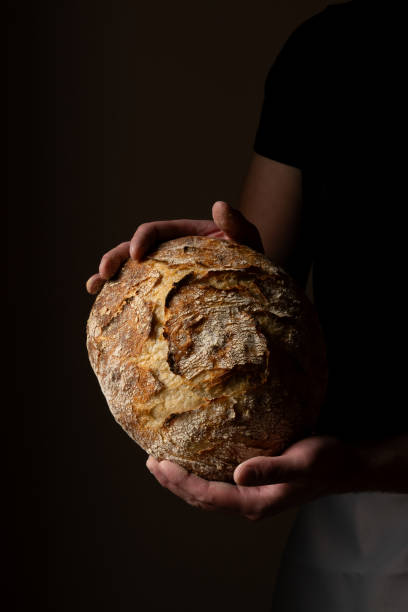 istock Attractive young Caucasian chef posing with white sourdough bread. 1759796290