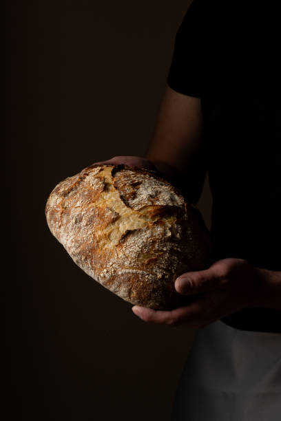 istock Attractive young Caucasian chef posing with white sourdough bread. 1759796291