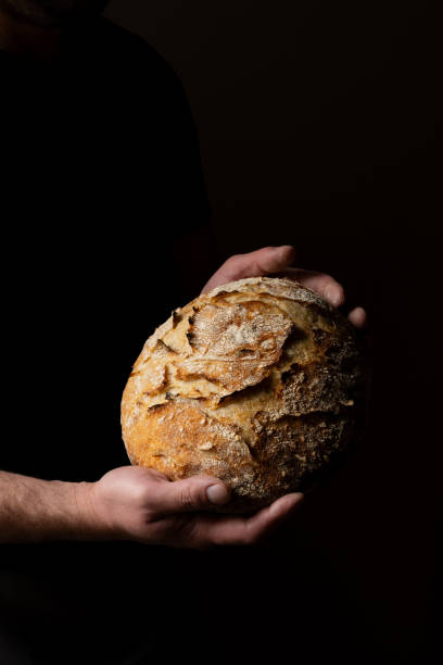 istock Attractive young Caucasian chef posing with white sourdough bread. 1759796309