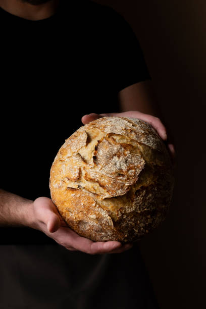 istock Attractive young Caucasian chef posing with white sourdough bread. 1759799023