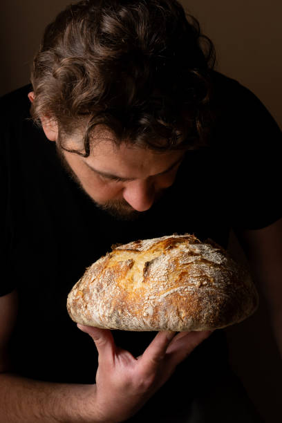 istock Attractive young Caucasian chef posing with white sourdough bread. 1759799035