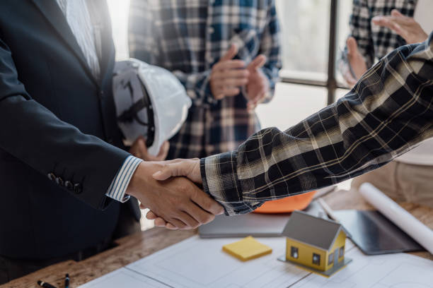 istock Asian engineer and architect shaking hands After working together to build a successful home and donning a shiny outfit, work on an industry-related construction design project. 1759803449
