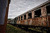At a lost place. An old passenger car with smashed windows, at a station at the end of the world.