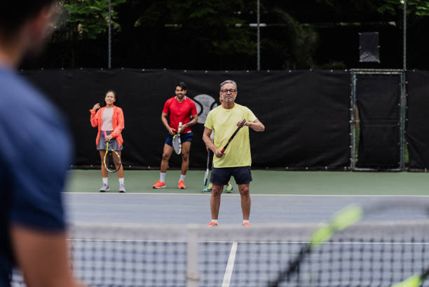 istock Senior man playing tennis during tennis class 1759818664
