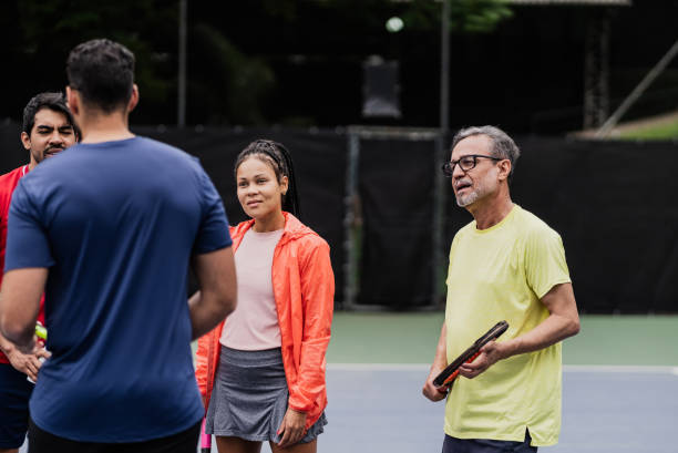istock Coach talking to students during tennis class 1759819265