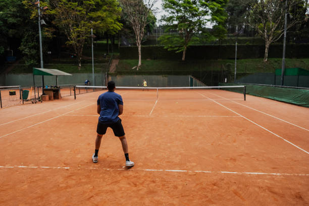 istock Young man playing tennis 1759820416