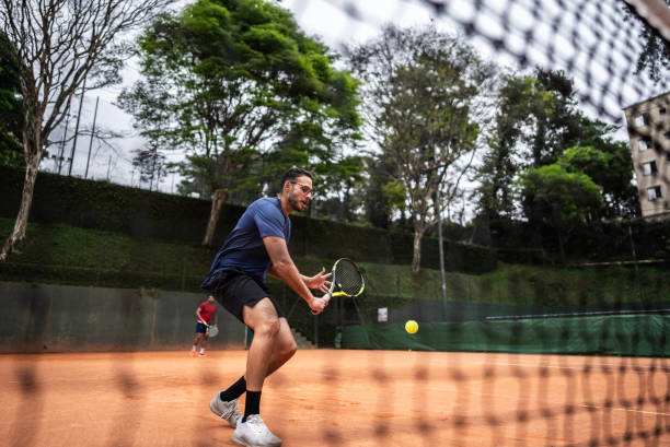 istock Young man playing tennis 1759820673