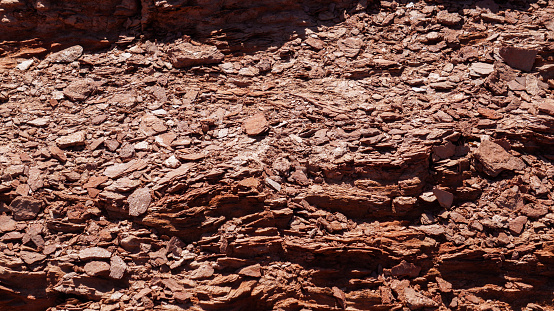 top view of  desertic rocky red floor texture. Taken on a warm spring afternoon under a clear blue sky