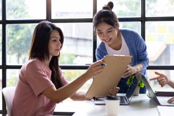 istock Group of colleagues at work are discussing and exchanging ideas in office having casual discussion during meeting in conference room. Group of university students working together in the library. 1759830052