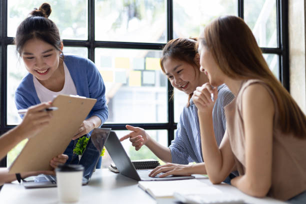 istock Group of colleagues at work are discussing and exchanging ideas in office having casual discussion during meeting in conference room. Group of university students working together in the library. 1759830075