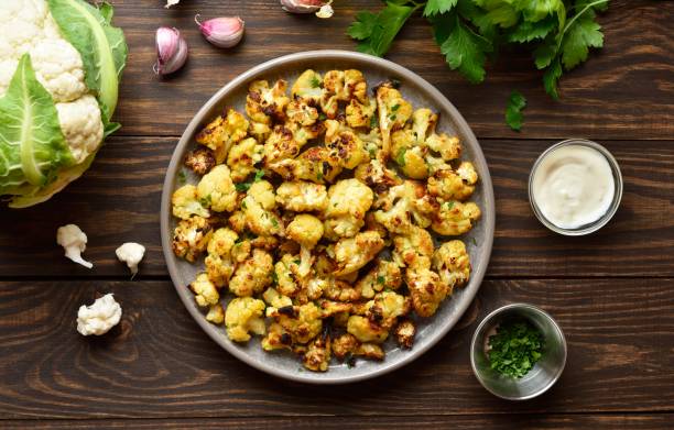 istock Roasted cauliflower on wooden background 1759833635