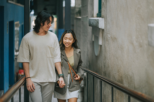 Asian Chinese couple tourist walking in city street in Hong Kong