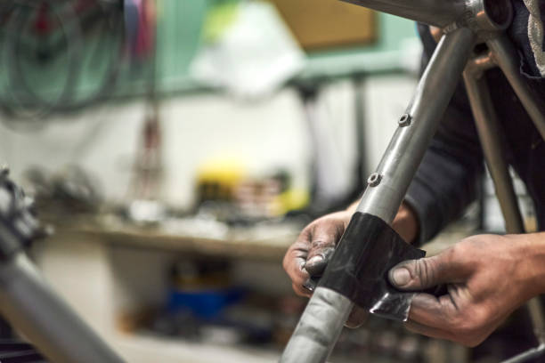 istock Hands of an unknown person sanding a bicycle frame at his workshop 1759885731
