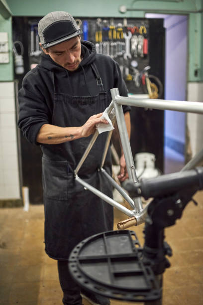 istock Latin man preparing a bicycle frame to paint in his workshop. 1759893190