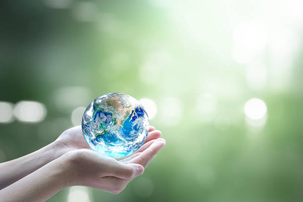 istock World environment day concept:Human hands holding earth globe on blurred beautiful green background. Elements of this image furnished by NASA 1759898591