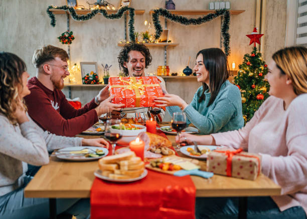 istock Friends exchanging gifts on Christmas 1759900207