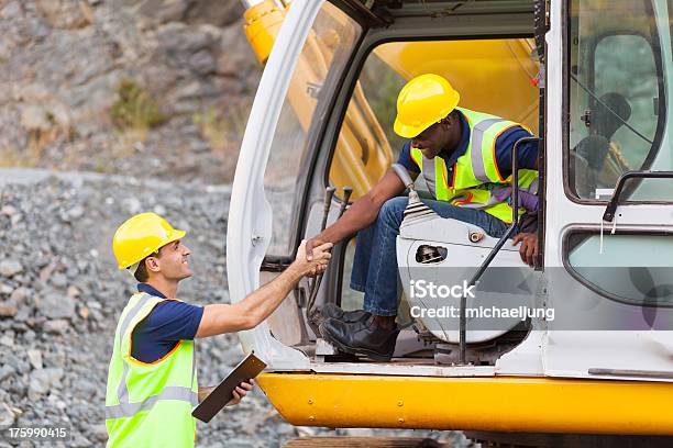 Construction Manager Handshaking With Bulldozer Operator Stock Photo - Download Image Now