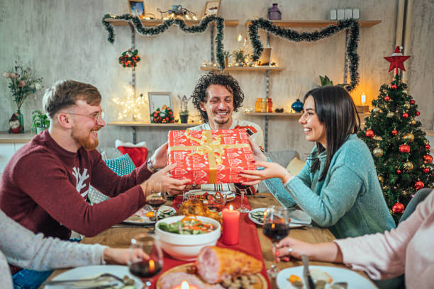 istock Friends exchanging Christmas presents 1759908534