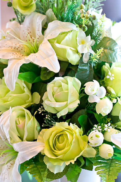istock Green rose and white lily artificial flowers bunch. 175990998