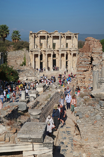 Ephesus, Turkey, October 17, 2023. Ancient ruined city of Ephesus, near Port of Kusadasi. Area of detail featuring the Library of Celsus with large numbers of tourists. Outdoors on a sunny day