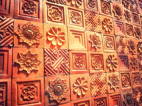 Bricks molded with ornamental shapes for wall decoration