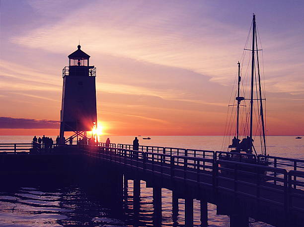 istock A lighthouse on the water at sunset 175993109