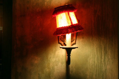 A grungy old lamp on a grungy old wall.View other