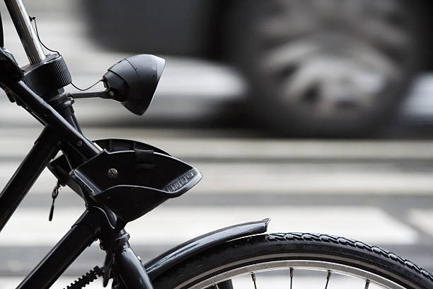 istock Bicycle vs Car wheels detail 175994106