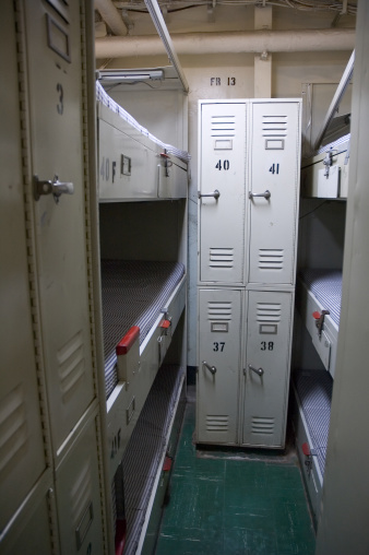 Bunks and lockers on a US aircraft carrier.  Very little room in these tight berths for months at a time.  Slightly grainy due to low light conditions.Click on image below to view more military shots: