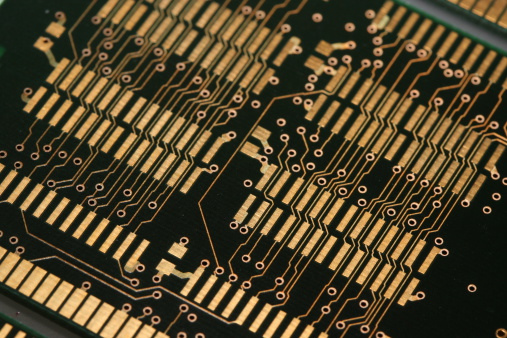 A green PCB printed circuit board with gold plated pads and wirings