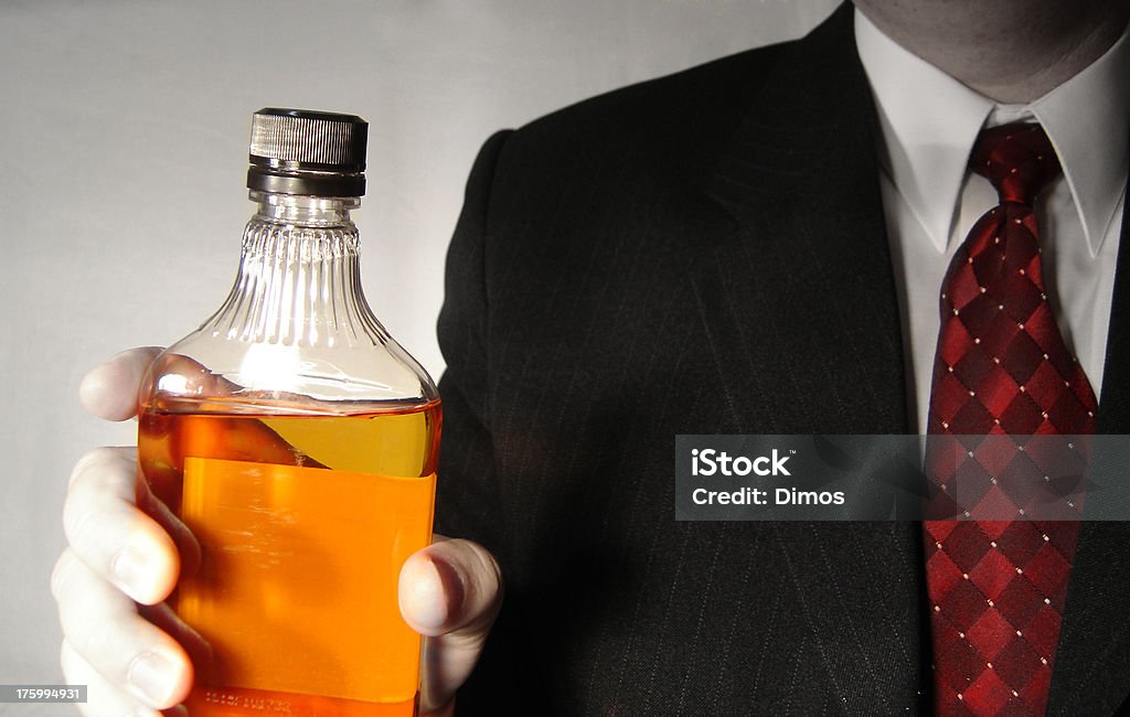 Drink ? a businessman is keeping in his hand a bottle with alcohol Alcohol - Drink Stock Photo